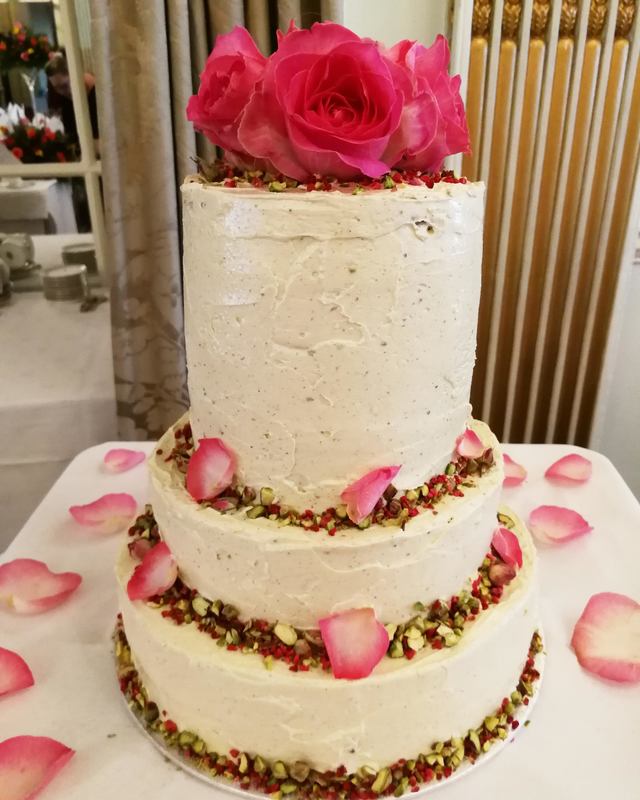 Four tier pistachio and rose wedding cake